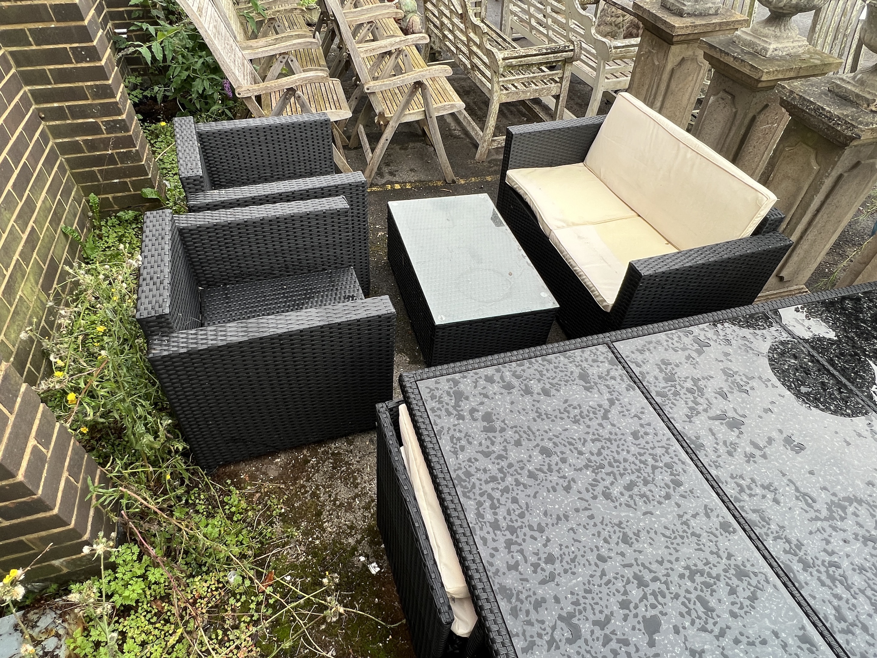 A black all weather rattan rectangular garden table and chair set, width 166cm, depth 109cm, height 67cm together with a matching three piece garden set with coffee table